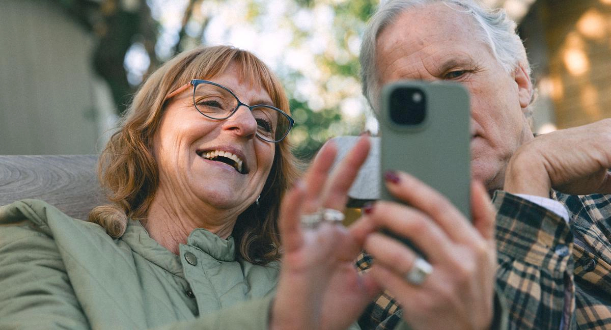 Ett par i pensionsåldern installerar BankID i mobilen.