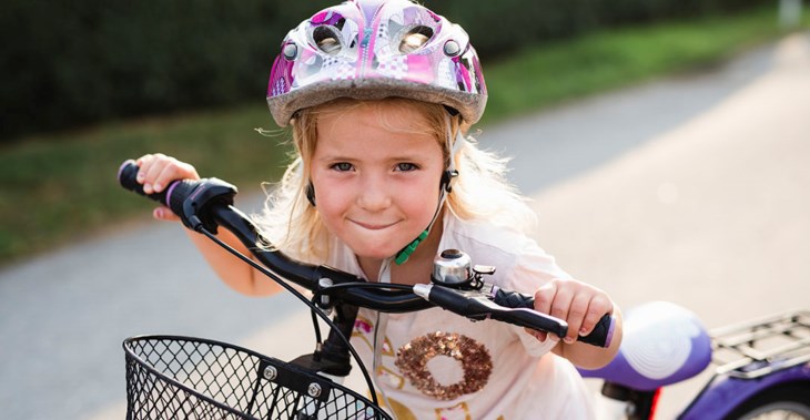 Flicka på cykel, porträtt.
