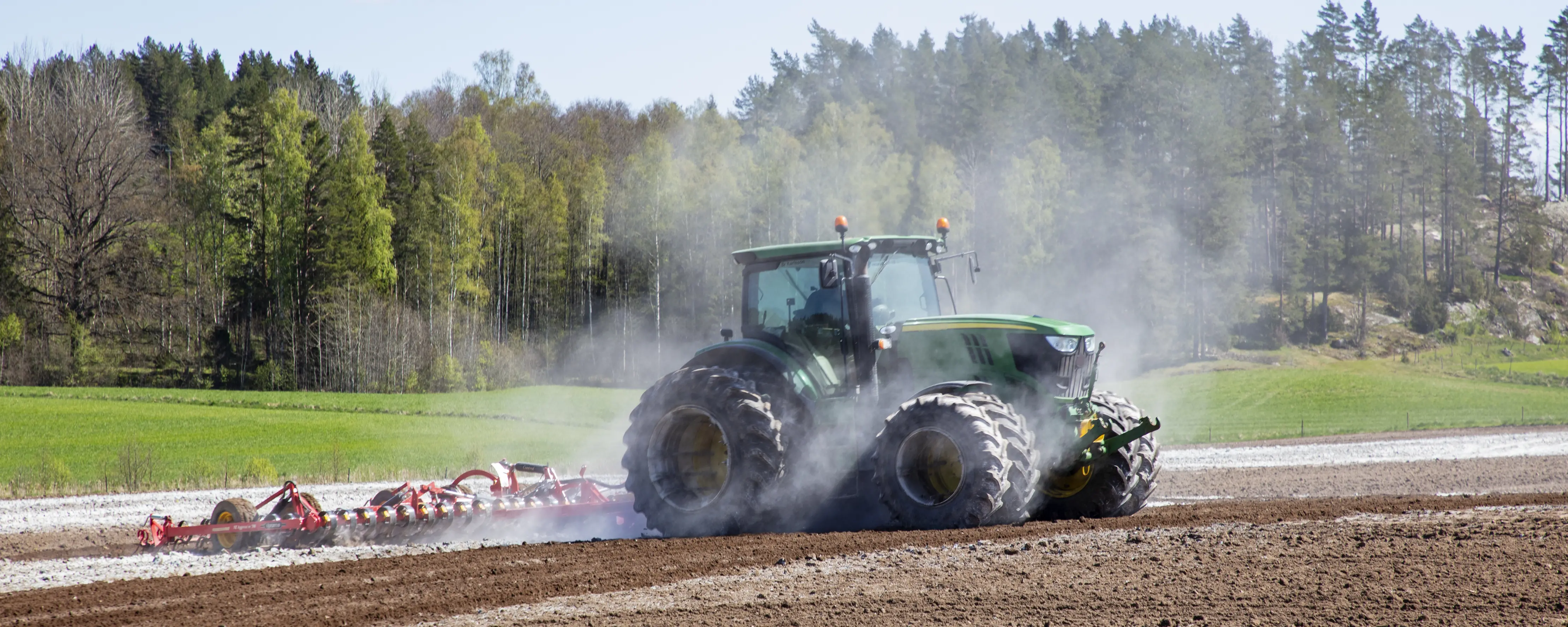Traktorförsäkrad traktor på åker.