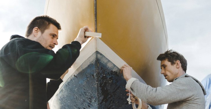 Män maskeringstejpar båt.