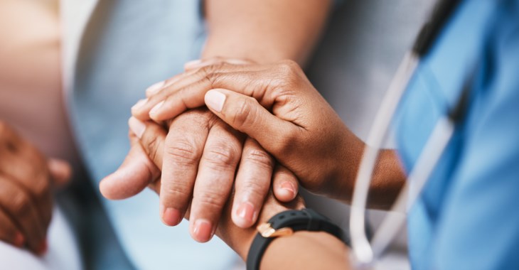 Bild på en läkares och patients händer