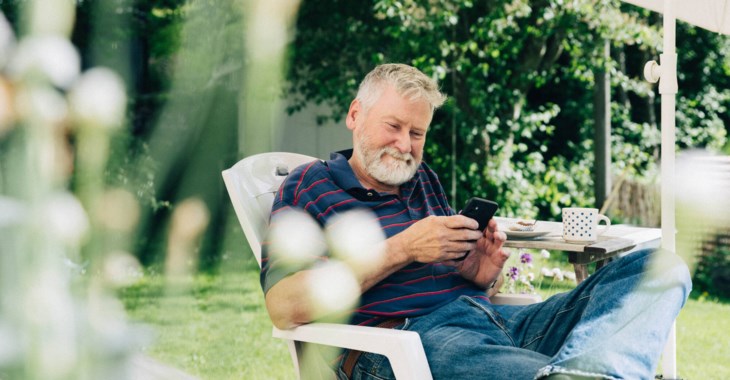 man läser om valet utomhus.